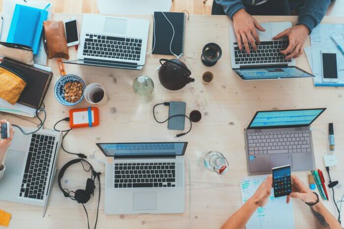 Group of people looking at social media insights on their computers