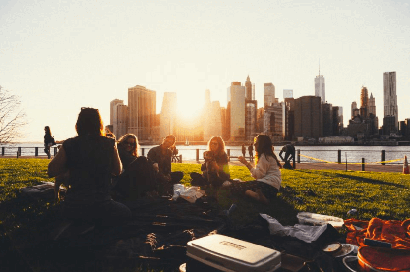 Group of college students hanging out in a park
