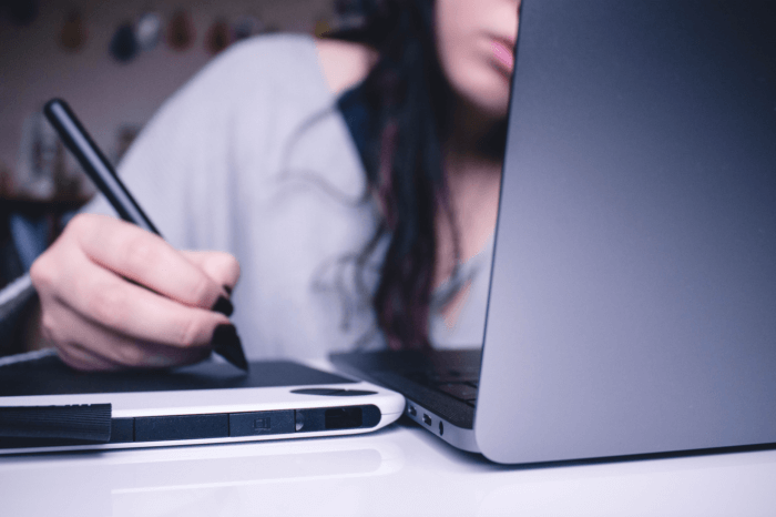 Woman editing images on a computer to comply with copyrights.