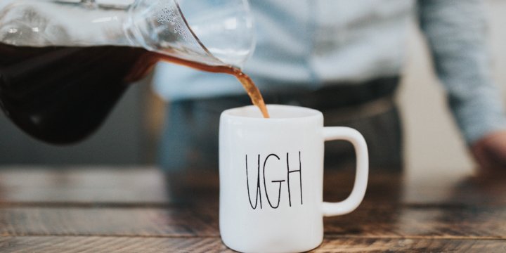 Coffee being poured into a mug that reads "Ugh"