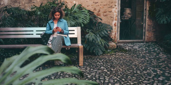 Woman sitting on an outdoor bench