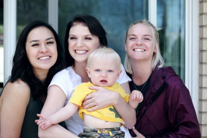 A group of three moms and a baby