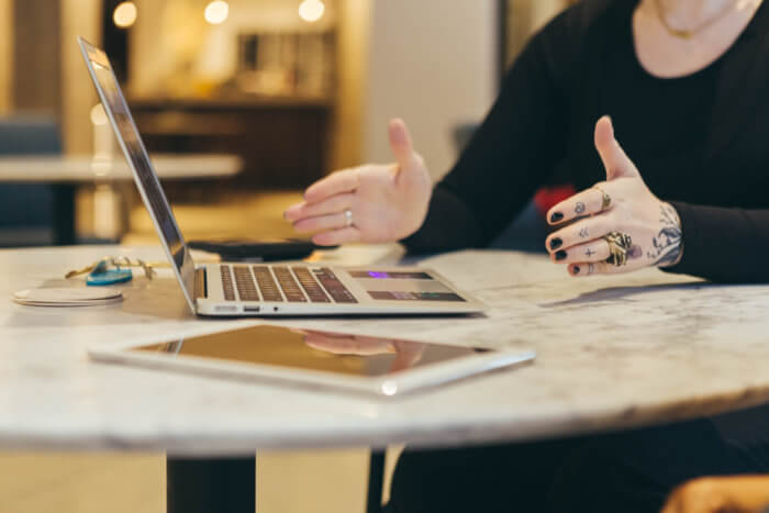 Community specialist in front of laptop and iPad is a critical member of any social media team