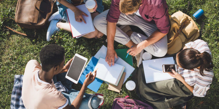 undergraduate students gathered and looking at the results of the 2019 higher education engagement report