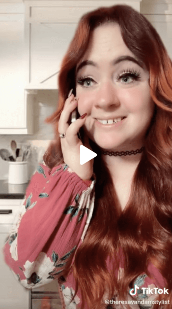 Theresa Van Dam screen shot featuring a still of the red-headed creator on the phone