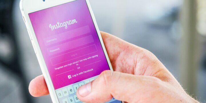 person holding phone with Instagram login page displayed