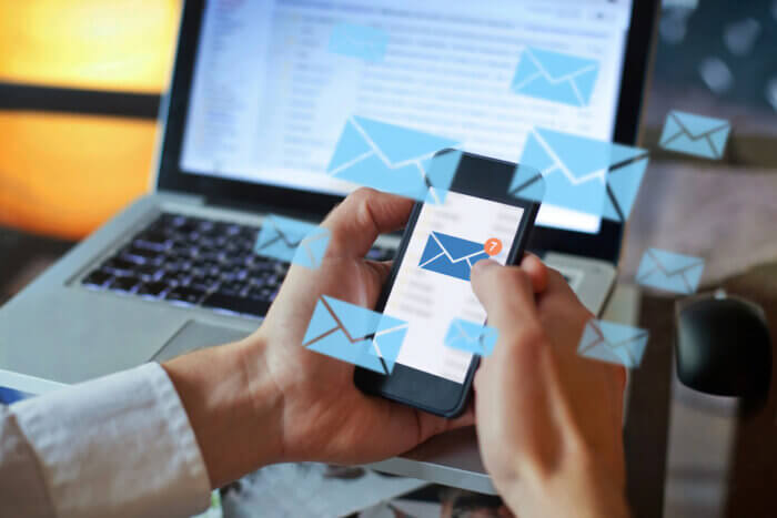 Person inundated with emails. Social media insights can help you break through the noise.