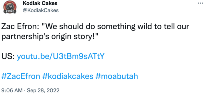 Screenshot of Kodiak Cakes' tweet sharing a video that shows Zac Efron's partnership with the brand. Hashtags with this tweet include #zacefron and #kodiakcakes.