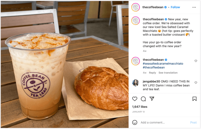 A mouth watering Instagram post from The Coffee Bean and Tea Leaf showcasing an iced coffee with a croissant. The caption accompanying this post asks if your go-to coffee order changed with the new year. Answers from the brand's followers contributes to an increase in engagement rate, a top metric to measure social media success.