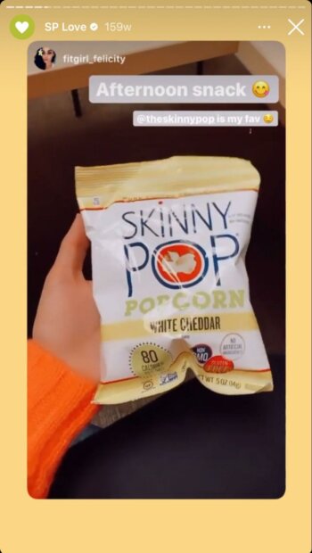 Beloved popcorn brand Skinny Pop reposts a user's story where they're holding a packet of the healthy snack, sharing their love for the product.