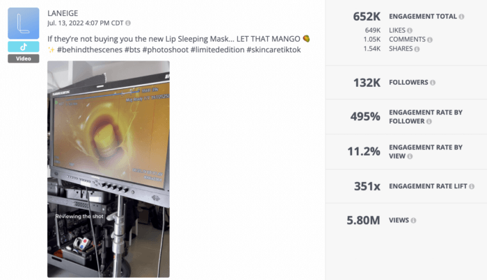 A Rival IQ analysis of a TikTok video from top beauty brand LANEIGE. The video takes followers behind the scenes by revealing a monitor at a photoshoot that's displaying a lip mask being dropped into a yellow liquid.