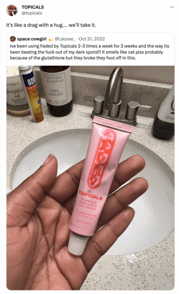 Topicals response to the tweet from their follower @space cowgirl who is holding up the brand's product over a sink praising it's effectiveness in removing dark spot inspite of its unpleasant smell.