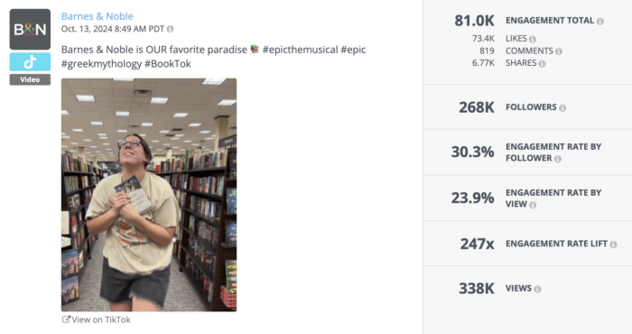 Excited person clutching a book while walking through Barnes & Noble aisles, expressing love for reading